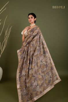 This exquisite handloom tussar silk saree features intricate gota and pearl work, handcrafted with precision and care. The digitally printed design adds a modern touch to this traditional piece, while the soft and flowy fabric ensures comfort and elegance. The perfect choice for those seeking a smart and contemporary saree. Diwali Cotton Silk Saree With Gota Work, Gold Cotton Silk Pre-draped Saree With Gota Work, Gold Pre-draped Cotton Silk Saree With Gota Work, Unstitched Cotton Silk Saree With Gota Work, Festive Tussar Silk Pre-draped Saree With Printed Border, Gold Cotton Silk Saree With Gota Work, Designer Tussar Silk Pre-draped Saree With Printed Border, Semi-stitched Tussar Silk Saree With Gota Work, Tussar Silk Saree With Gota Work In Traditional Drape