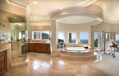 a large bathroom with an oval tub and walk in shower