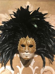 "This masquerade mask for men belongs to our collection of feathers' masks. These masks have a crown of black feathers similar to the one used in the movie of Stanley Kubrick \"Eyes Wide Shut\". It is perfect for any masquerade party, Halloween costume, pro or event in Venice or elsewhere during Carnival. This mask can be gently bent to form to your face and ties in the back with two soft matching ribbons. Size: one-size This kind of mask is also perfect as in interior design element, wall decor Black Masks For Carnival Themed Events, Black Feathered Masquerade Mask For Costume Party, Carnival Feather Eye Mask, Feathered Masquerade Mask For Costume, Black Feathered Masquerade Mask, Feathered Eye Mask For Costumes, Carnival Masquerade Masks And Prosthetics With Feathers, Feathered Masks And Prosthetics For Carnival Masquerade, Black Full Face Carnival Masks