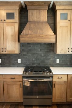 a stove top oven sitting inside of a kitchen next to wooden cupboards and cabinets