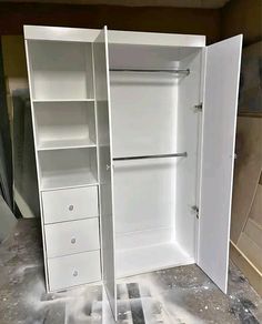 an empty closet is shown in the process of being painted and filled with white paint