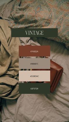 an open suitcase sitting on top of a bed next to pillows and blankets with the words vintage above it