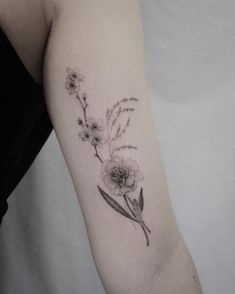 a woman's arm with a flower tattoo on the left side of her body