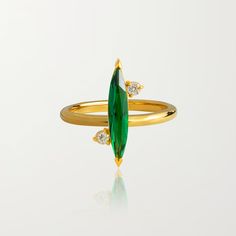 Sizing Help? Sleek and sophisticated, the Verde Ring is crafted with a large emerald marquis and lab-grown diamonds to bring a pop of color to your finger stack. Perfectly paired with any of our emerald jewelry. Composition: Lab-Grown diamonds 0.024 carats. Green marquis colored stones 18K Gold Vermeil: Our 925 Recycled Sterling Silver is coated in the highest quality thick gold vermeil. This guarantees top quality and long lasting product that you can wear in all conditions. Hypoallergenic, wat Jewelry Composition, 2024 Wishlist, Bow Arrows, Colored Stones, Emerald Jewelry, Gems Jewelry, Recycled Sterling Silver, Jewel Tones, Huggies Earrings