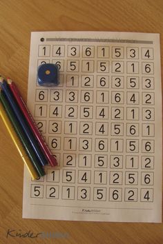 two colored pencils are next to a number puzzle