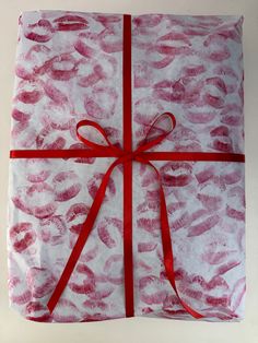 a wrapped present with red ribbon on white background