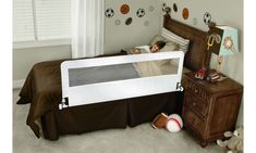 a child's bed with a baseball theme on the wall