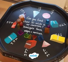 a black board with colorful cubes and numbers on it that says can you find these 30 - solids in our classroom?