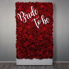 a red flower wall with the words bride to be written on it