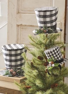 two buckets are sitting on top of a christmas tree