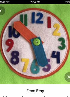 a close up of a clock made out of felt with numbers on the front and back