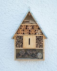 a bird house made out of wood with holes in the roof and metal grids