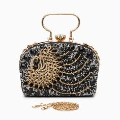 Decked out in magnificent peacock-patterned rhinestones, this clutch exudes unparalleled uniqueness and flair. Beyond its stunning appearance, it blends functionality seamlessly with style, featuring a chic chain strap and ample interior space. Its splendid design encapsulates sophistication, guaranteeing that every graceful movement catches the eye and turns heads. Now available in gold, and black. Chain Clutch Evening Bag For Night Out, Glamorous Party Clutch With Bling, Luxury Chain Clutch For Party, Elegant Bling Evening Bag For Parties, Elegant Evening Bag With Bling For Parties, Glamorous Rhinestone Clutch For Night Out, Elegant Rectangular Sequin Clutch, Glamorous Bling Evening Bag For Party, Luxury Party Clutch With Chain