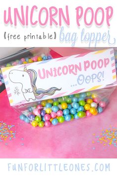 a unicorn poop bag topper next to some candy