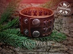 This leather bracelet or wrist cuff is inspired by Viking art and jewelry and is made of a thick leather base covered with an X pattern weaving. This bracelet is sized to best fit wrists measuring between 6.25 and 7.5 inches in circumference. It has a three-position snap button system so you can adjust it to better fit your wrist. I would not recommend it for wrists measuring any larger than 7.5 inches.MORE DETAILS- Made of thick brown leather.- Measures 1.4 inches in width.- Measures 8.25 inche Leather Wristbands, Viking Art, Wrist Cuffs, Braided Bracelets, Snap Button, Wrap Bracelet, Vikings, Leather Bracelet, Brown Leather