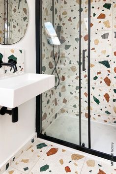 a white sink sitting next to a walk in shower