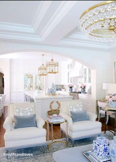 a living room filled with furniture and a chandelier