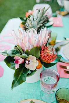 the table is set with flowers and plates