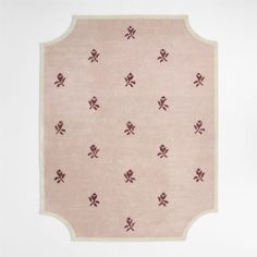 a pink rug with red crosses on it