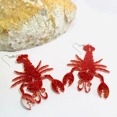 Red glitter lobster acrylic earrings laser cut from 3mm red glitter acrylics. The lobsters are jointed so they wiggle with your movement. Are you a lobster fan? Just imagine the conversations you will have wearing these!Earrings measured 2.8 inches long and 2 inches wide, not counting the hooks. These earrings can be made into clip on earrings.Earrings will be placed in a gift box, carefully packed and shipped, perfect as a gift for yourself or a loved one.Any questions? Please feel free to cont Lobster Earrings, Acrylic Earrings Laser Cut, Laser Cut Jewelry, Glitter Acrylics, Halloween Earrings, Wood Earrings, Red Glitter, Acrylic Earrings, Scary Halloween