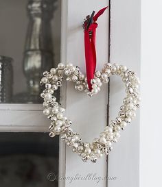 a heart shaped wreath hanging on the front door