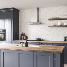 a large kitchen with gray cabinets and wooden counter tops, along with an island in the middle