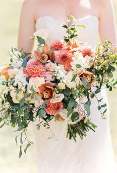 a bride holding a bouquet of flowers in her hands