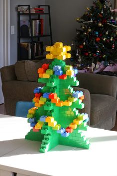 a christmas tree made out of legos sitting on a table in front of a couch