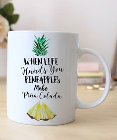 a white coffee mug with the words when life hands you pineapples make pina cola