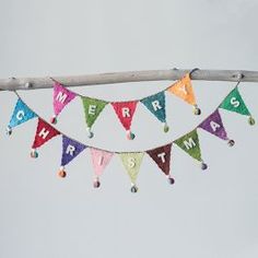 a colorful banner with the words we are happy hanging from a tree branch