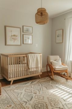 a baby's room with a crib, rocking chair and pictures on the wall