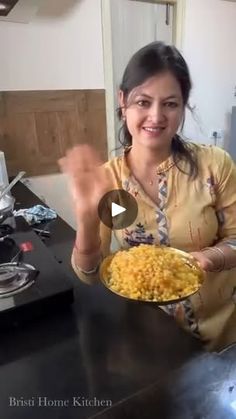 a woman holding a plate of food in her hands