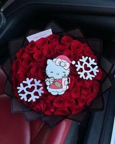 a bouquet of red roses in the shape of a hello kitty and snowflakes