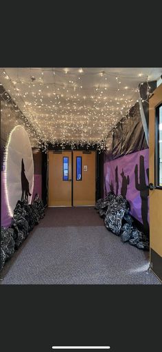 an entrance to a building decorated with lights and bags on the ground in front of it