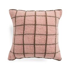 a pink and brown pillow on a white background