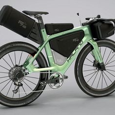 an electric bicycle with luggage strapped to the seat and front wheel, on a gray background