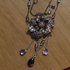 Floral, Silver Plated, Two Strand Necklace. Flowered Pendant Is Surrounded By Different Shades Of Purple Austrian Crystals, As Well As Clear Austrian Crystals. Necklace Hangs 10 Inches With A 2 Inch Extender. Nwot. Dark Purple Jewelry, Victorian Purple Necklace As Gift, Victorian Style Hallmarked Purple Necklaces, Gothic Amethyst Necklace Gift, Antique Purple Hallmarked Necklace, Vintage Purple Pendant Necklace, Different Shades Of Purple, Necklaces Crystal, Silver Pearl Jewelry