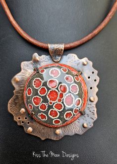 Discover the Unique Charm of Our Large Crackle Enamel and Copper Necklace Elevate your accessory game with the Large Crackle Enamel and Copper Necklace in stunning shades of grey and red. Each necklace is a masterpiece, crafted through a meticulous process of fusing powdered glass to copper, resulting in a pendant that is not only beautiful but also truly one of a kind. Key Features: Unique Design: Each pendant develops its own unique patterns during the firing process, making your necklace an e Collectible Red Medallion Jewelry, Red Enamel Jewelry With Large Pendant, Red Artistic Design Jewelry For Gift, Unique Red Jewelry With Artistic Design, Artisan Hand-painted Orange Jewelry, Artisan Hand Painted Orange Jewelry, Enamel Cabochon Round Pendant Necklace, Artisan Red Jewelry With Large Pendant, Round Pendant Necklace With Enamel And Cabochon