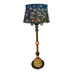 A beautiful vintage Mackenzie-Childs Grandiosity Floor Lamp with stunning attention to detail. It is made from scratch by the artisans in Aurora, New York at their headquarters. It has faux marbling, courtly stripes, gold lustre and brass buttons. A custom embroidered shade lined with gold fabric and trimmed beaded fringe. A black ceramic songbird perches on top. Wrought Iron Floor Lamps, Art Deco Floor Lamp, Chic Lamp, Iron Floor Lamp, Cork Flooring, Brass Buttons, Brass Floor Lamp, Made From Scratch, Mackenzie Childs