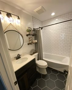 a white toilet sitting next to a bath tub in a bathroom