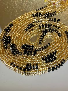 **Please allow up to 5-7 business days for processing time for Waistbeads, Free US Shipping for orders over $75 ** Our stunning Black Love Waistbeads, are perfect for adding a touch of elegance and tradition to your style. These waistbeads feature a beautiful Black and Gold throughout the waistbead. Crafted with high-quality 8/0 and 6/0 glass beads, they offer both durability and beauty. Designed to fit most with a standard length of 60", these traditional tie-on waistbeads allow you to customiz Party Faceted Round Beads, Polished Beaded Bracelets For Party, Party Beaded Bracelets With Polished Beads, Elegant Gold Beads With Black Details, Party Polished Round Beaded Bracelets, Elegant Waist Beads With Spacer Beads As Gift, Elegant Waist Beads With Spacer Beads For Gift, Festive Gold Beaded Necklaces With Black Beads, Elegant Faceted Waist Beads As Gift