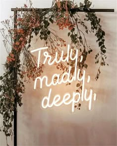 a neon sign that says truly, madly, deeply