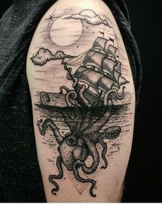 an octopus and ship tattoo on the arm