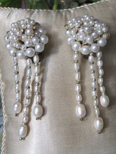 Pearl Dangly Earrings These lovely clip on vintage earrings ooze femininity and would complement any outfit.  The irregular dangles are genuine lustrous water pearls strung with tiny silver beads in between. So chic. The pearls on the clip are faux pearls. Excellent condition Vintage Dangle Earrings For Anniversary, Handmade Vintage White Clip-on Earrings, Vintage Beaded Clip-on Earrings As Gift, Vintage Beaded Clip-on Earrings For Gift, Vintage Handmade Clip-on Earrings For Party, Vintage Handmade Clip-on Earrings For Evening, Handmade Vintage Clip-on Earrings For Party, Handmade Formal Dangle Clip-on Earrings, Elegant Beaded Dangle Clip-on Earrings