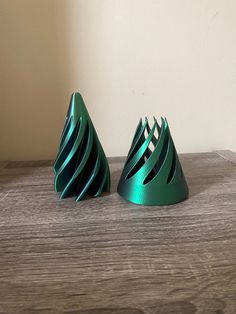 two green vases sitting on top of a wooden table