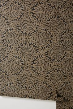 an intricately designed wallpaper in brown and black