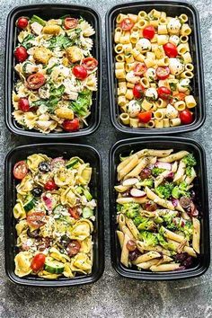 four plastic trays filled with different types of pasta and veggie salads