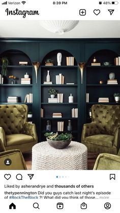 an instagram page with two chairs and a coffee table in front of bookshelves