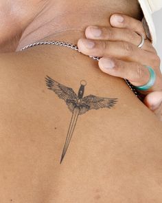 a woman with a bird tattoo on her back