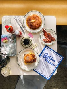 a table topped with plates of food and drinks